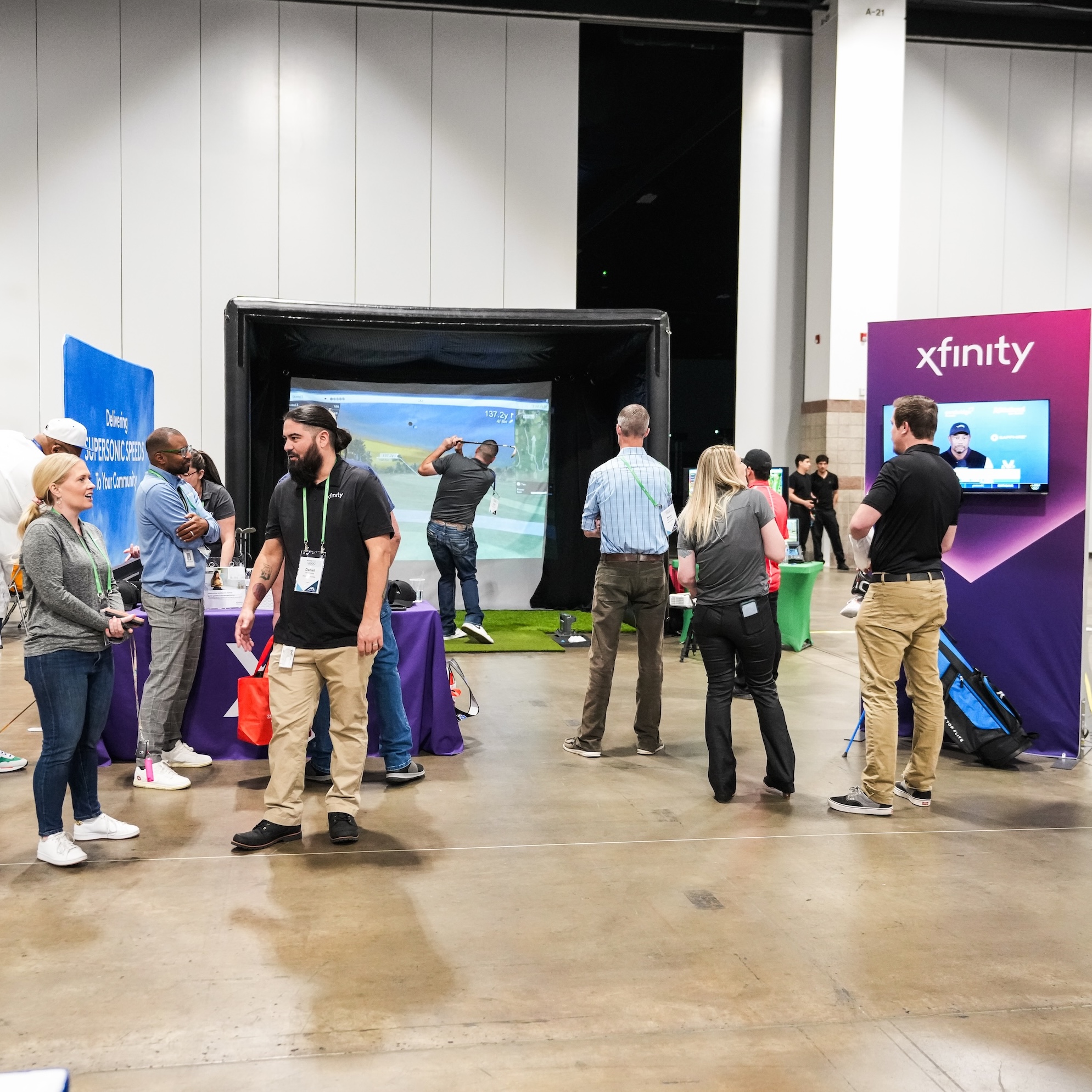 Golf simulator rental at Xfinity Comcast trade show booth at Colorado Convention Center in Denver